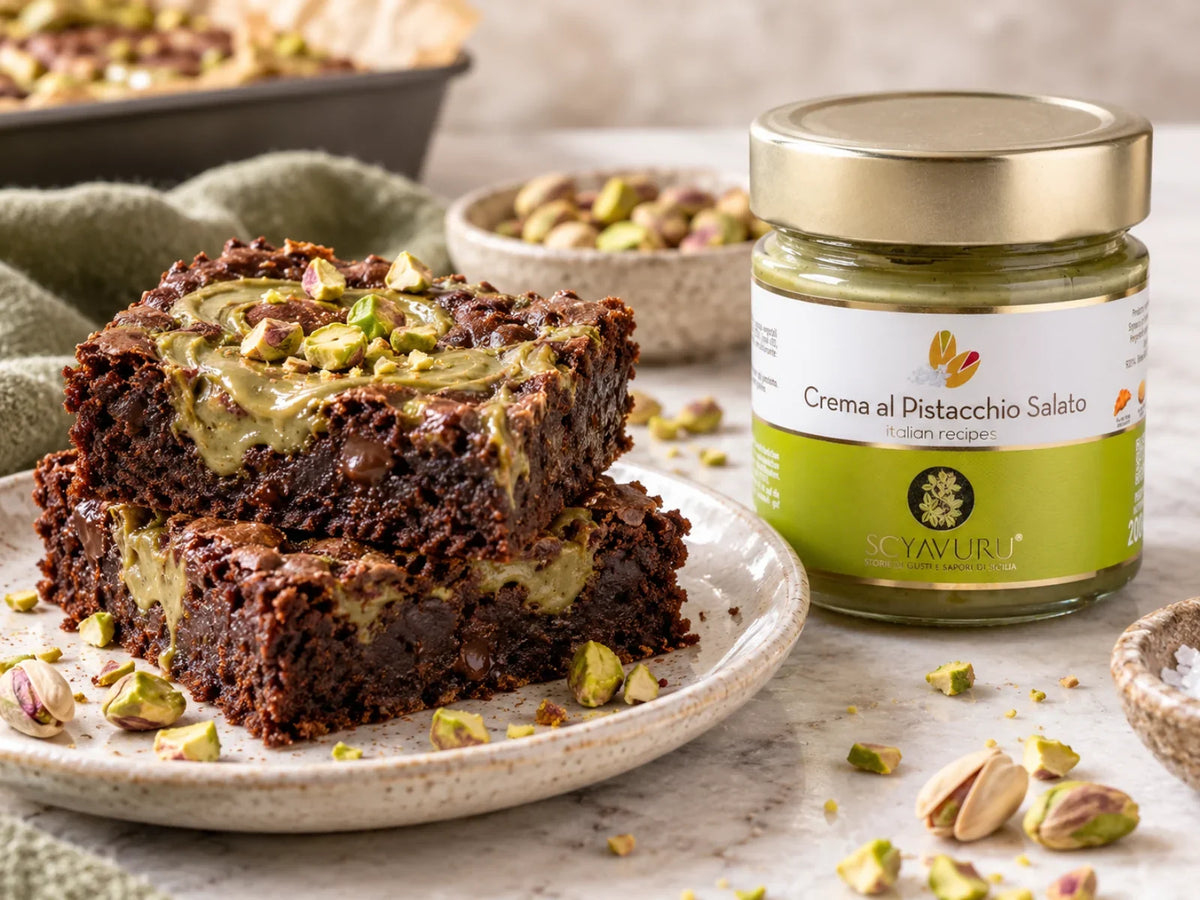 Pistaziencreme-Brownies mit Scyavuru Crema al Pistacchio Salato im Glas, angerichtet auf einem Teller mit gehackten Pistazien.